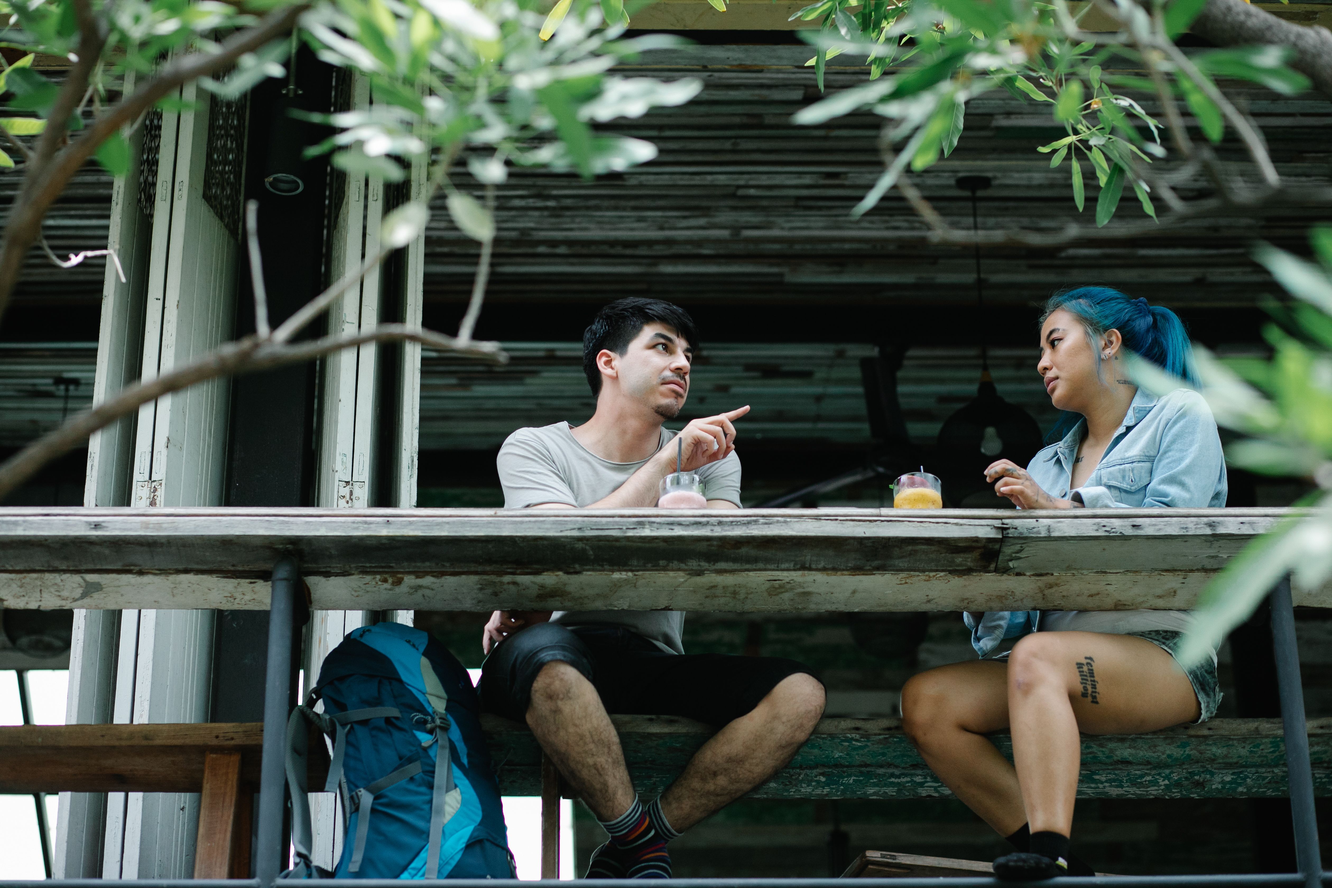 A couple enjoying drinks and conversation at an outdoor cafe, representing companionship and connection